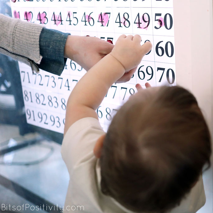 Helping Put Stickers on 100 Acts of Kindness Chart at 11 Months